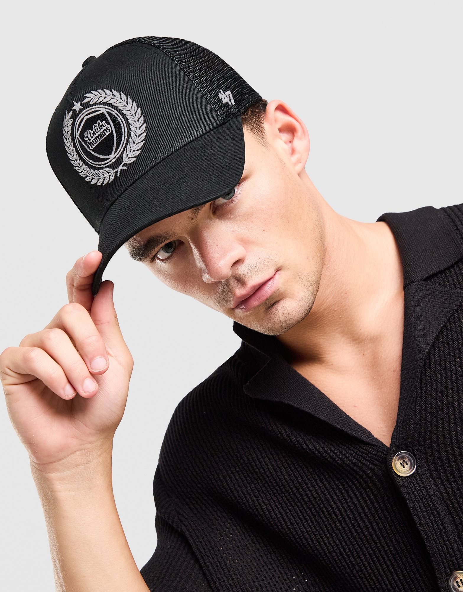 Unlike Humans Crest Trucker Cap